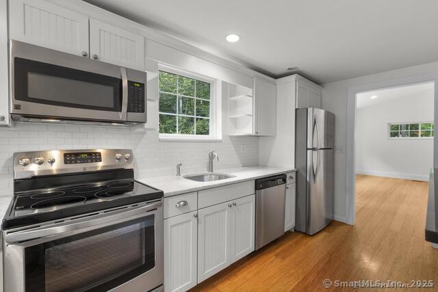 89 Book Hill Road Essex, CT 06426 - Photo 16 of 40 a kitchen with stainless steel appliances a stove a sink and a microwave