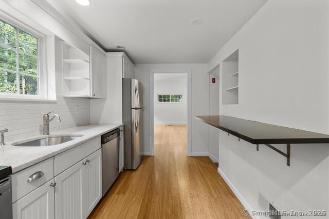 89 Book Hill Road Essex, CT 06426 - Photo 17 of 40 a kitchen with a sink and wooden floor