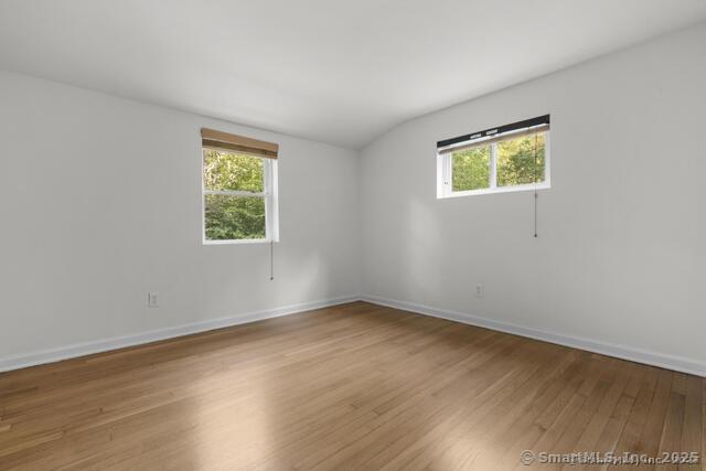 89 Book Hill Road Essex, CT 06426 - Photo 18 of 40 a view of an empty room with wooden floor and a window