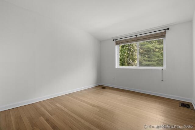 89 Book Hill Road Essex, CT 06426 - Photo 24 of 40 an empty room with wooden floor and windows