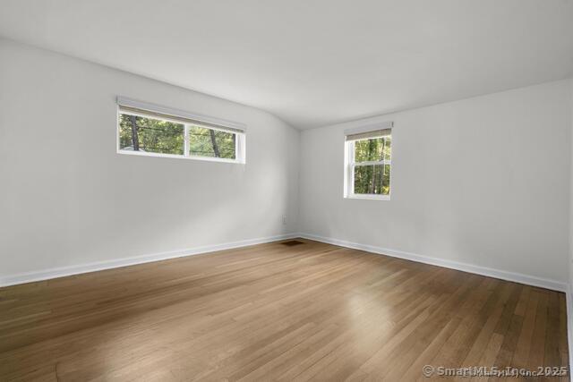 89 Book Hill Road Essex, CT 06426 - Photo 26 of 40 a view of an empty room with wooden floor and a window