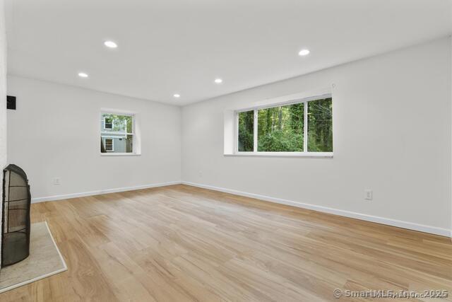 89 Book Hill Road Essex, CT 06426 - Photo 28 of 40 an empty room with wooden floor and windows
