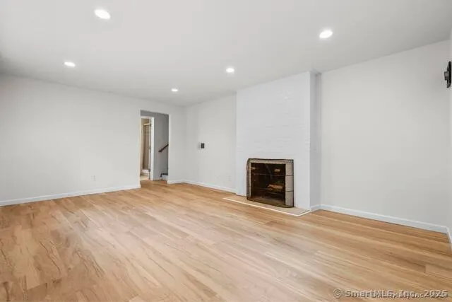 a view of an empty room with a fireplace