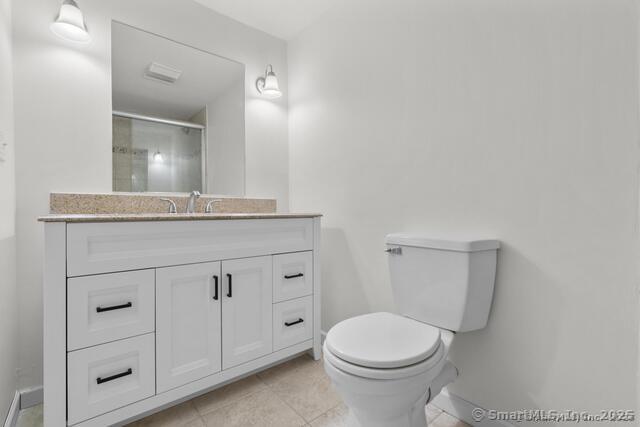 89 Book Hill Road Essex, CT 06426 - Photo 30 of 40 a bathroom with a granite countertop toilet sink and mirror