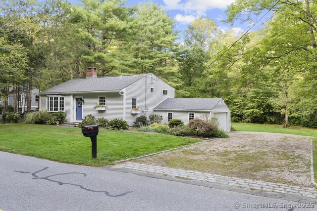89 Book Hill Road Essex, CT 06426 - Photo 39 of 40 a front view of a house with a garden and trees