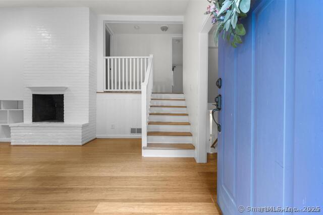 89 Book Hill Road Essex, CT 06426 - Photo 9 of 40 a view of a hallway with wooden floor and staircase