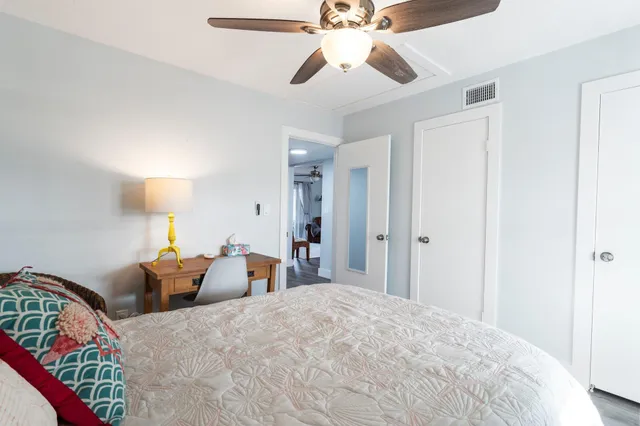 a bed room with bed and a chandelier