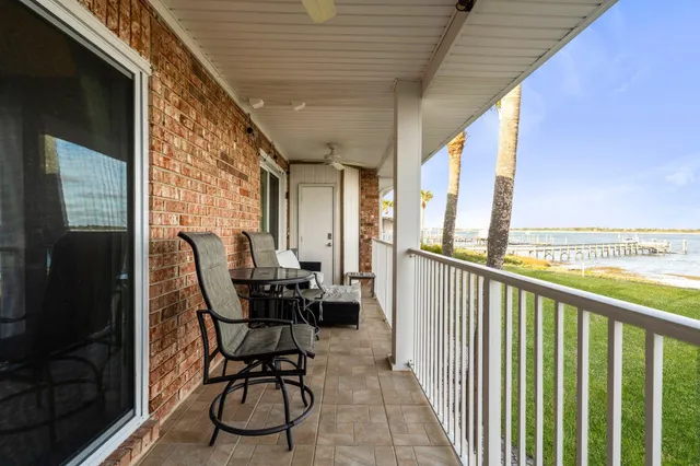 a view of a balcony with chairs and a table