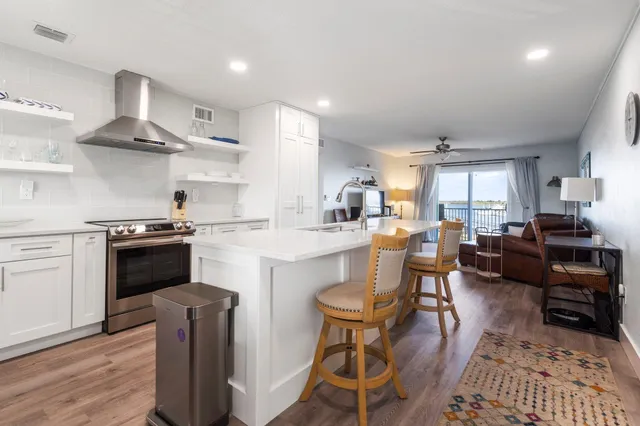 a kitchen with a sink cabinets and wooden floor