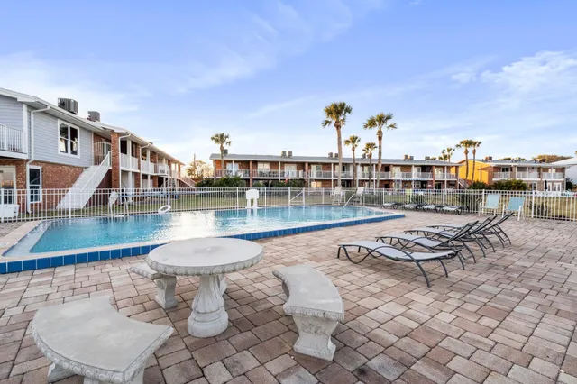 a swimming pool with outdoor seating and city view