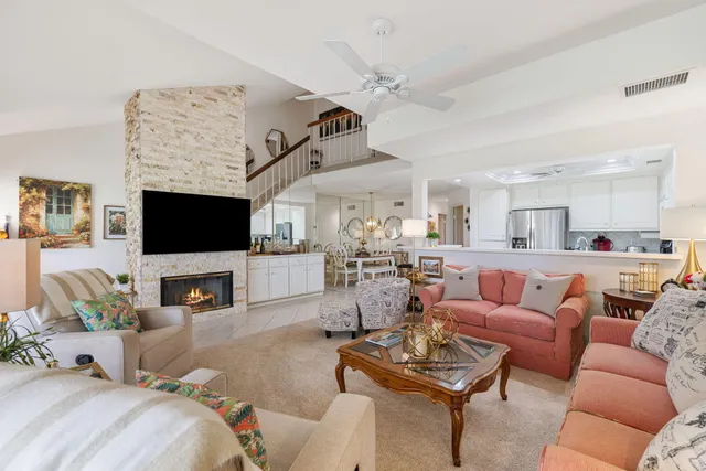 a living room with furniture a flat screen tv and a fireplace