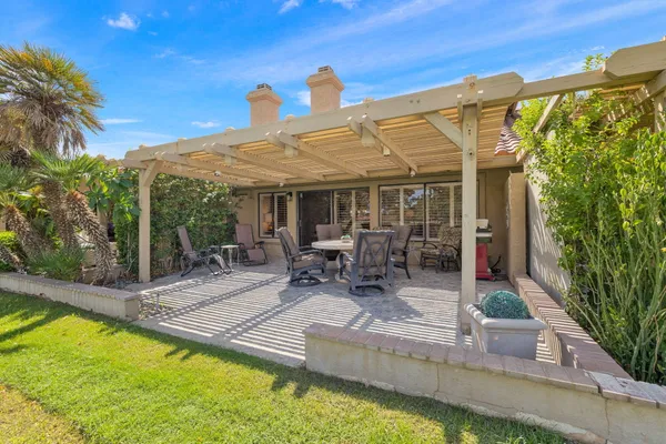 a view of a backyard with a sitting area and furniture