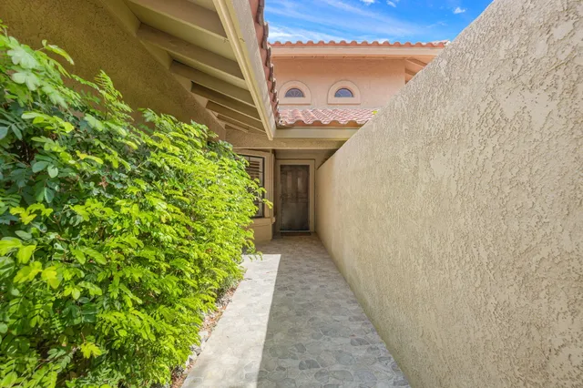 a hallway with flowers in front of door