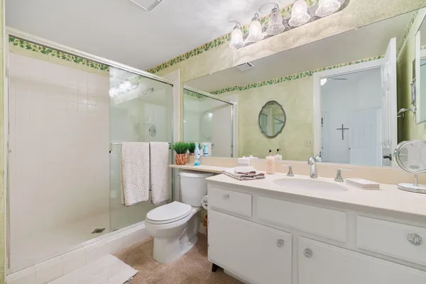 a bathroom with a double vanity sink mirror and toilet
