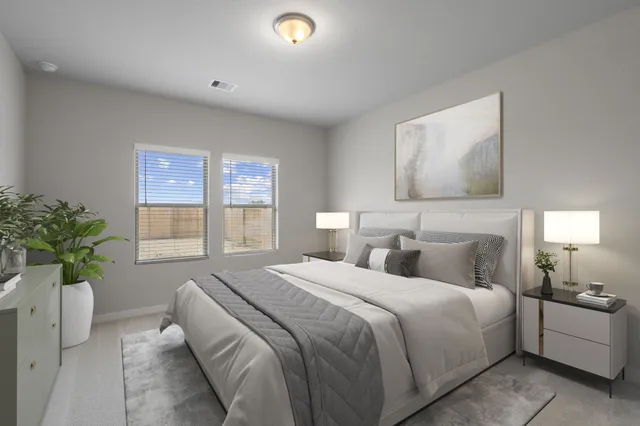 a bedroom with a bed and a potted plant