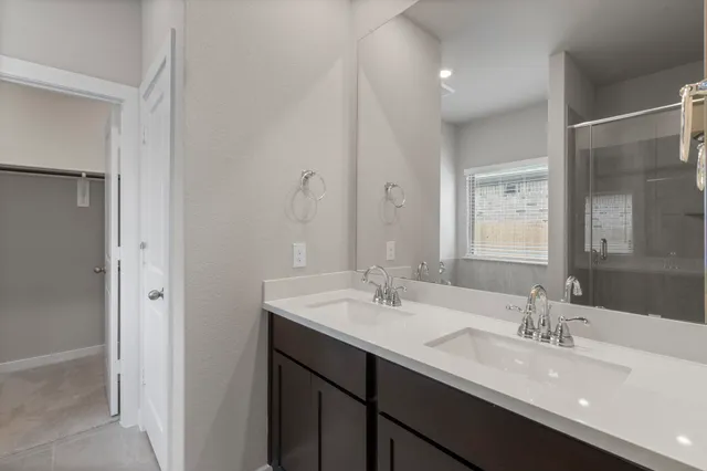 a bathroom with a double vanity sink mirror and double