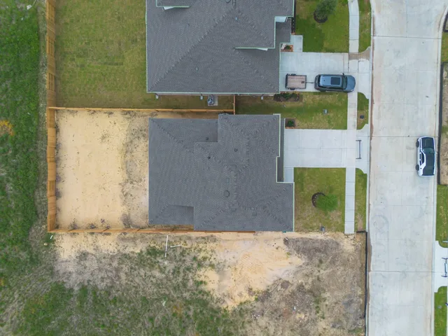 a front view of a house with a garden and yard