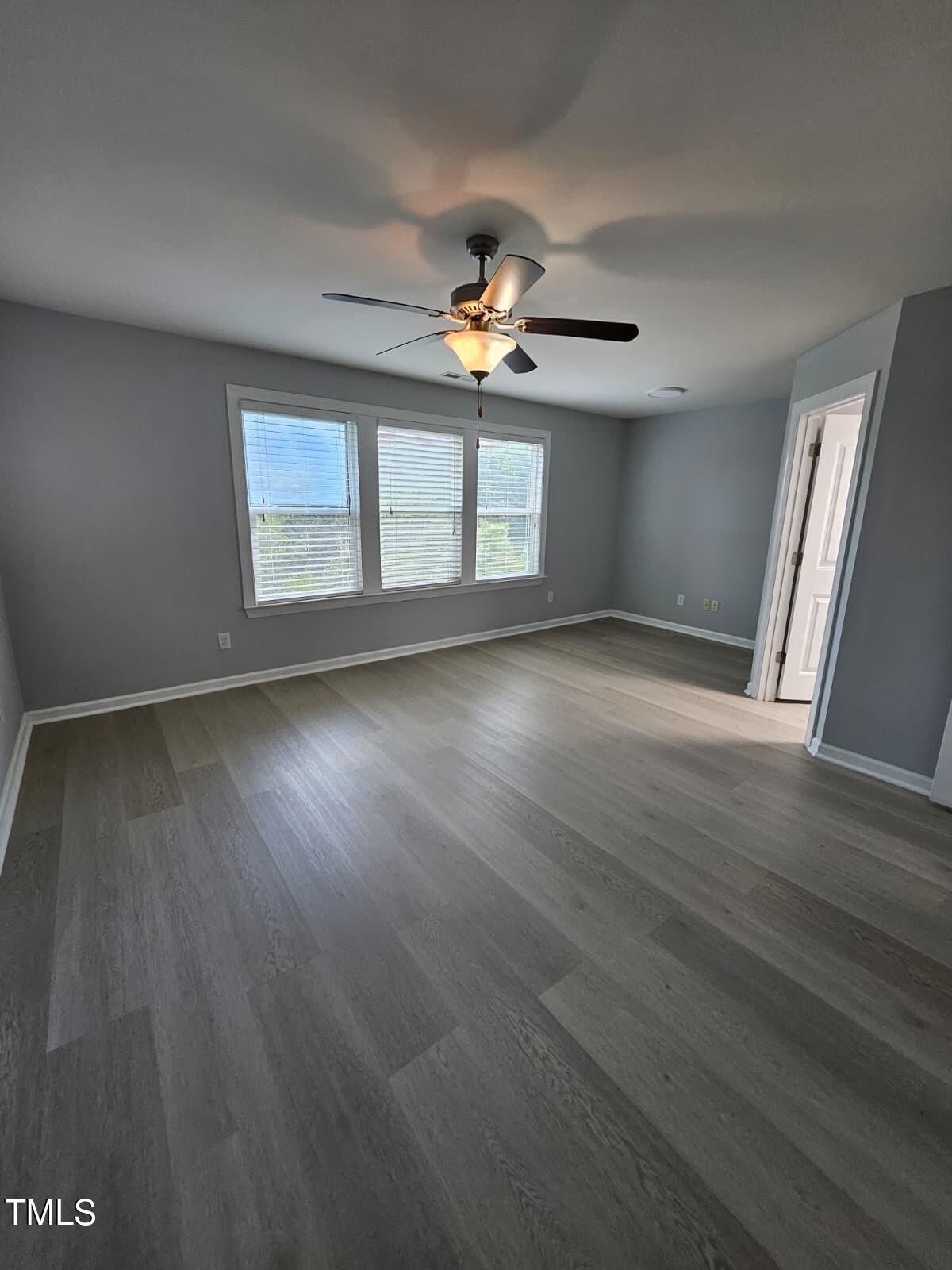 2205 Kirkhaven Road Morrisville, NC 27560 - Photo 13 of 36 a view of an empty room with a window and wooden floor