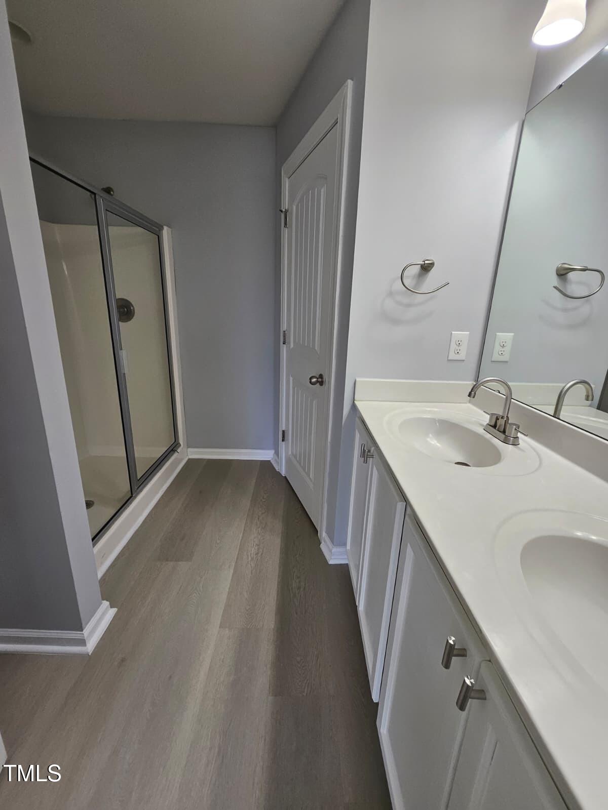 2205 Kirkhaven Road Morrisville, NC 27560 - Photo 16 of 36 a bathroom with a sink a mirror and a shower