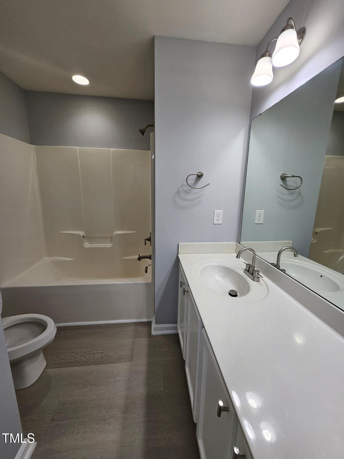 2205 Kirkhaven Road Morrisville, NC 27560 - Photo 20 of 36 a bathroom with a double vanity sink a toilet and a bathtub