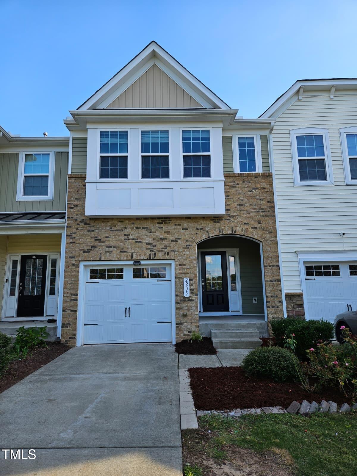 2205 Kirkhaven Road Morrisville, NC 27560 - Photo 2 of 36 a front view of a house with a yard and garage