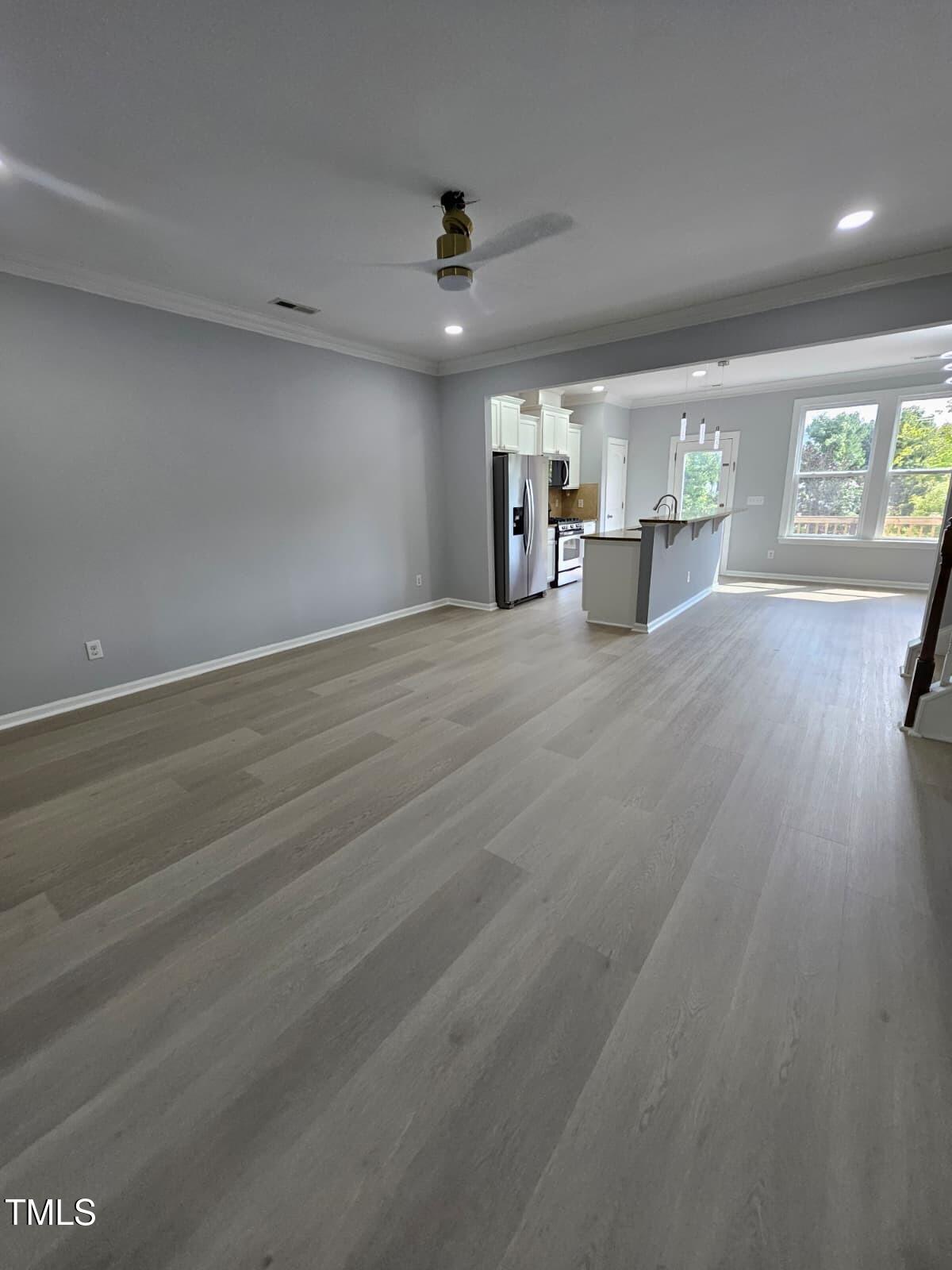 2205 Kirkhaven Road Morrisville, NC 27560 - Photo 5 of 36 a view of empty room with wooden floor and fan