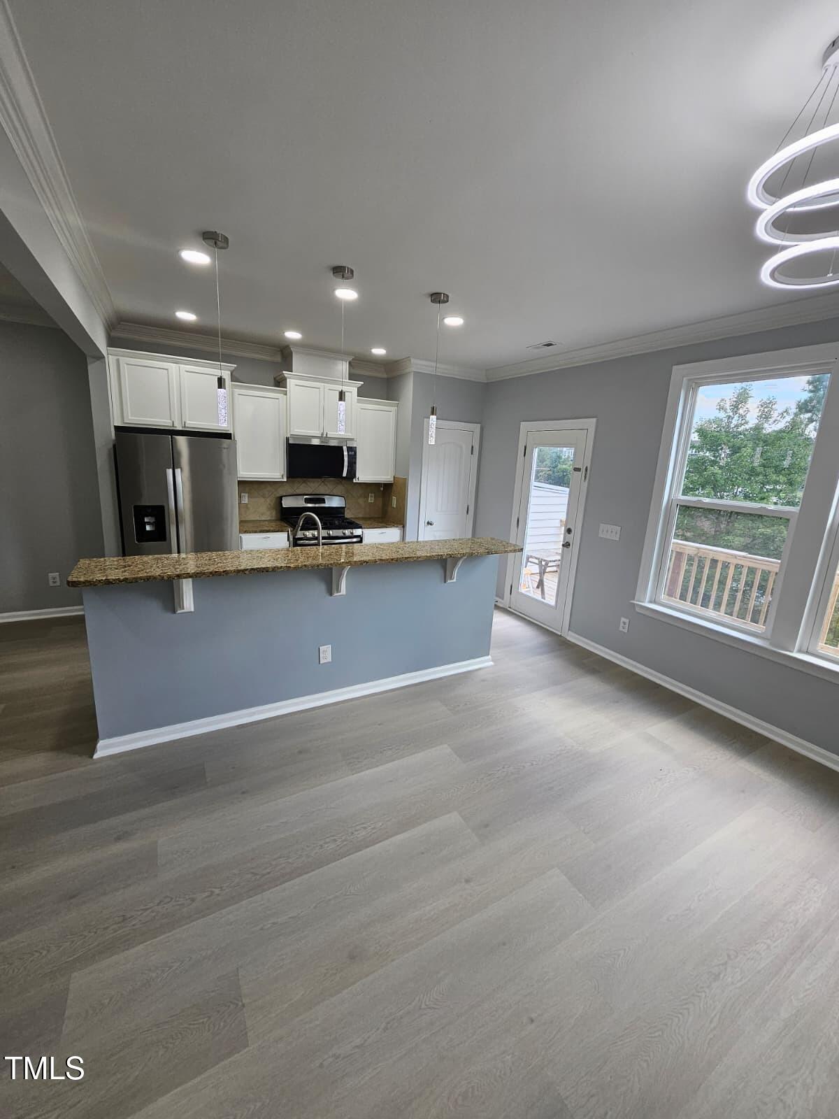 2205 Kirkhaven Road Morrisville, NC 27560 - Photo 10 of 36 a view of a kitchen with a sink and a stove top oven