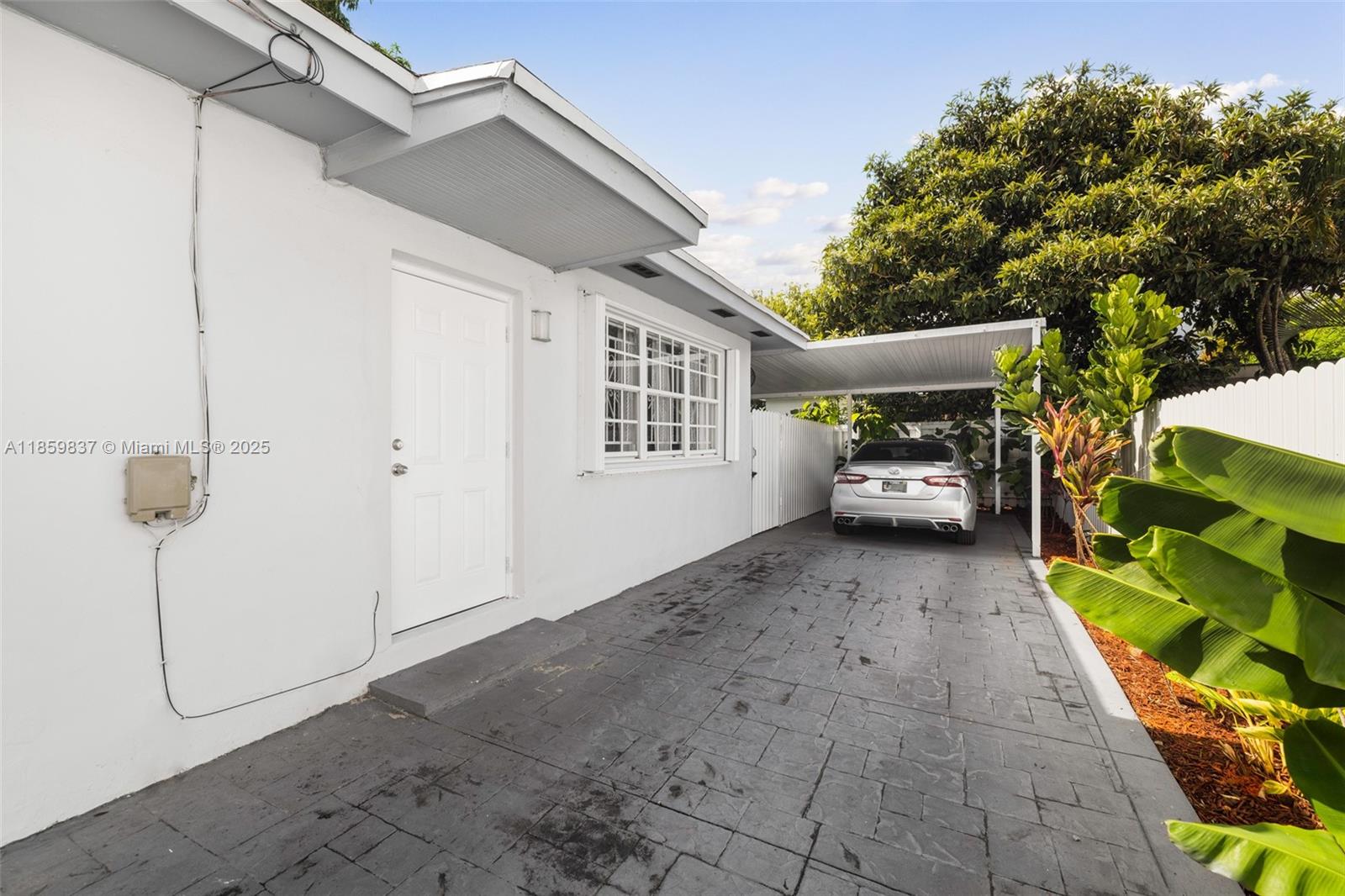 2928 Southwest 5th Street, Unit C Miami, FL 33135 - Photo 15 of 15 a view of a car parked in back yard of a house