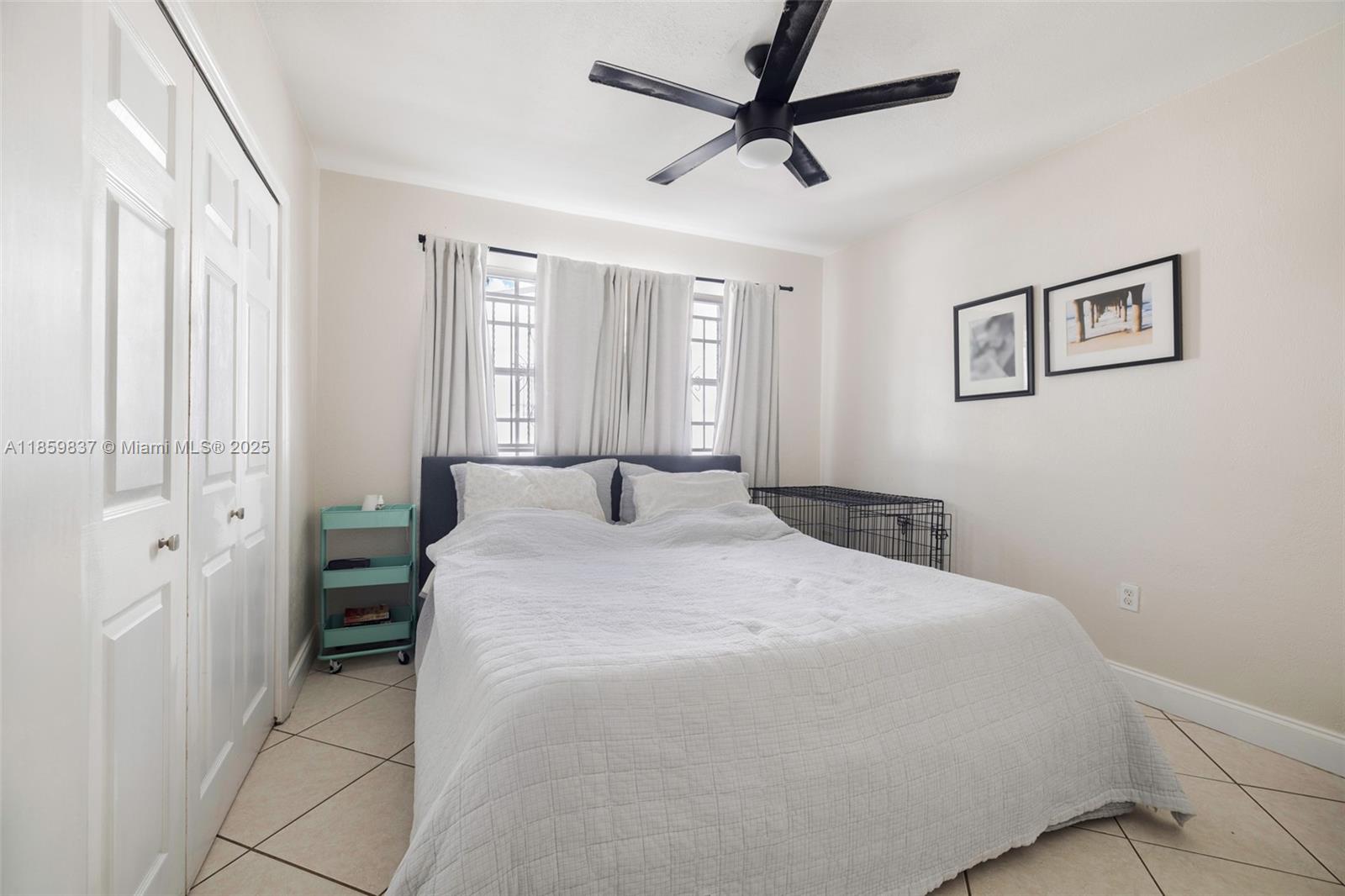 2928 Southwest 5th Street, Unit C Miami, FL 33135 - Photo 6 of 15 a bedroom with a large bed and a chandelier