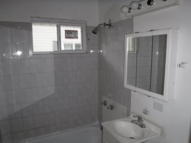 1131 146th Street Dolton, IL 60419 - Photo 15 of 15 a bathroom with a sink a toilet and shower