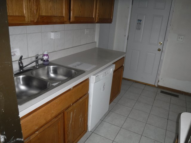 1131 146th Street Dolton, IL 60419 - Photo 8 of 15 a kitchen with a sink and cabinets