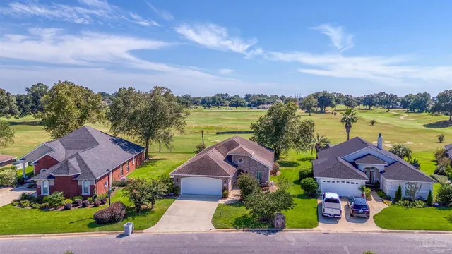 an aerial view of house with yard and ocean view
