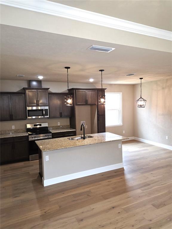 24338 Southwest 18th Road Newberry, FL 32669 - Photo 7 of 20 a view of a kitchen with a sink and microwave