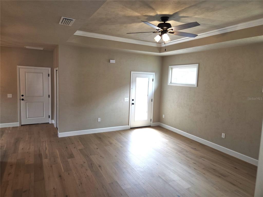 24338 Southwest 18th Road Newberry, FL 32669 - Photo 9 of 20 a view of an empty room with window and wooden floor