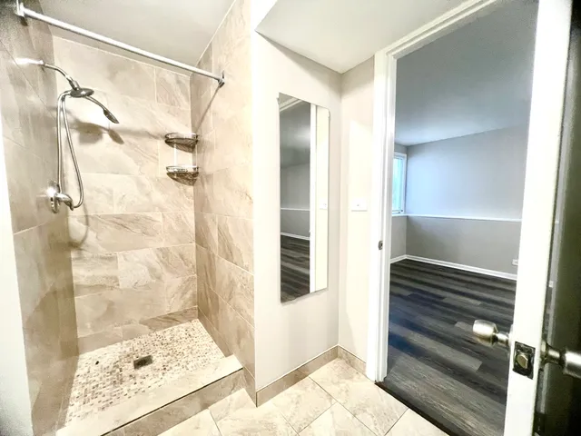 a bathroom with a shower and a glass door