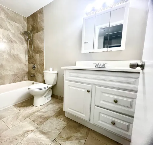 a bathroom with a sink a toilet and bathtub