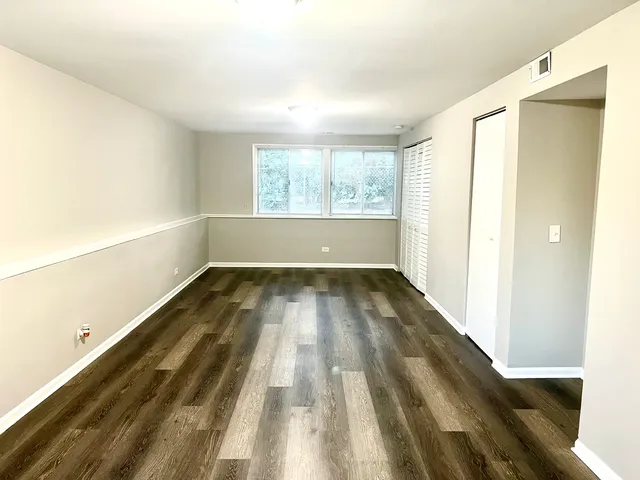 a view of room with window and hardwood floor