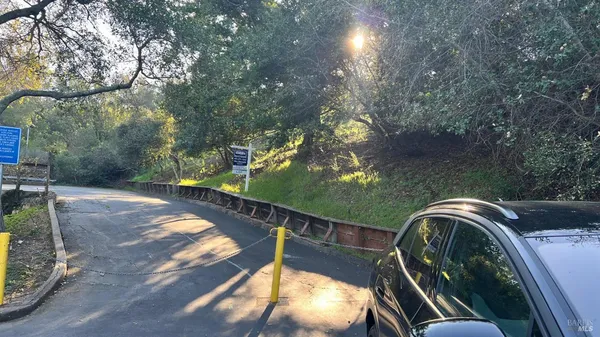 a view of a balcony with wooden floor and fence