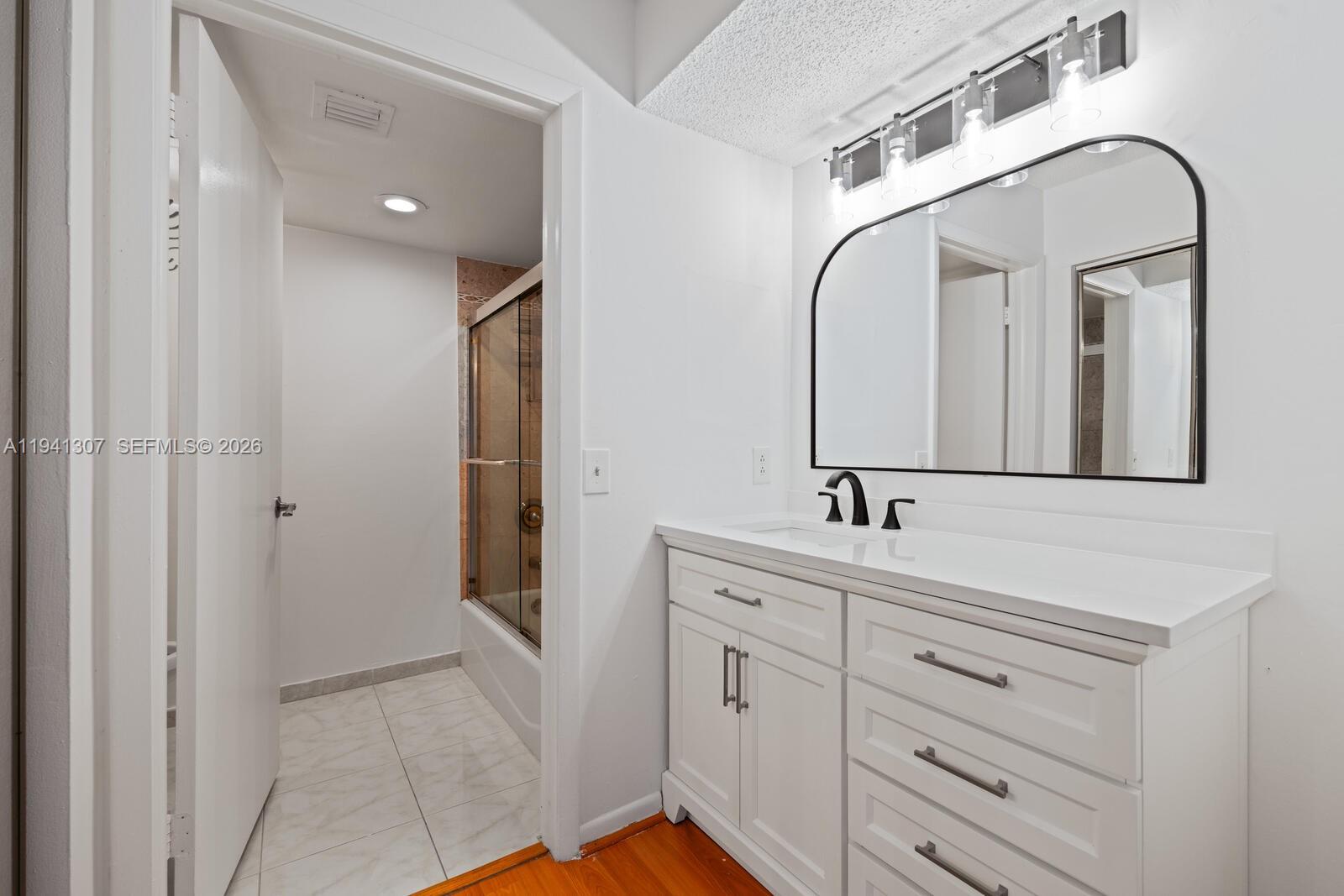 9500 Southwest 140th Court, Unit 9500 Miami, FL 33186 - Photo 14 of 21 a bathroom with a sink and a mirror