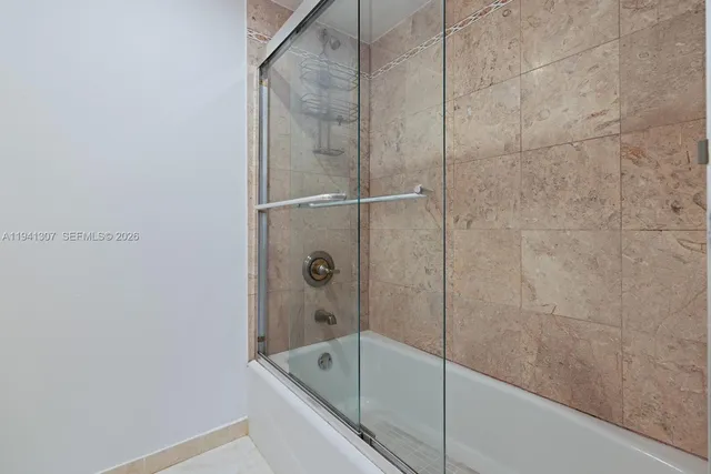 a bathroom with a bathtub and shower