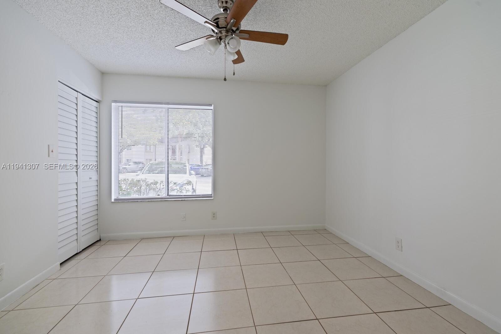 9500 Southwest 140th Court, Unit 9500 Miami, FL 33186 - Photo 16 of 21 a view of an empty room with a window