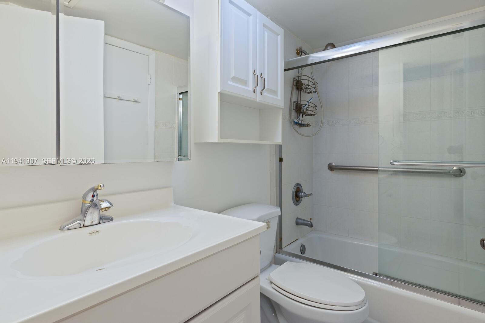 9500 Southwest 140th Court, Unit 9500 Miami, FL 33186 - Photo 18 of 21 a bathroom with a sink toilet and shower