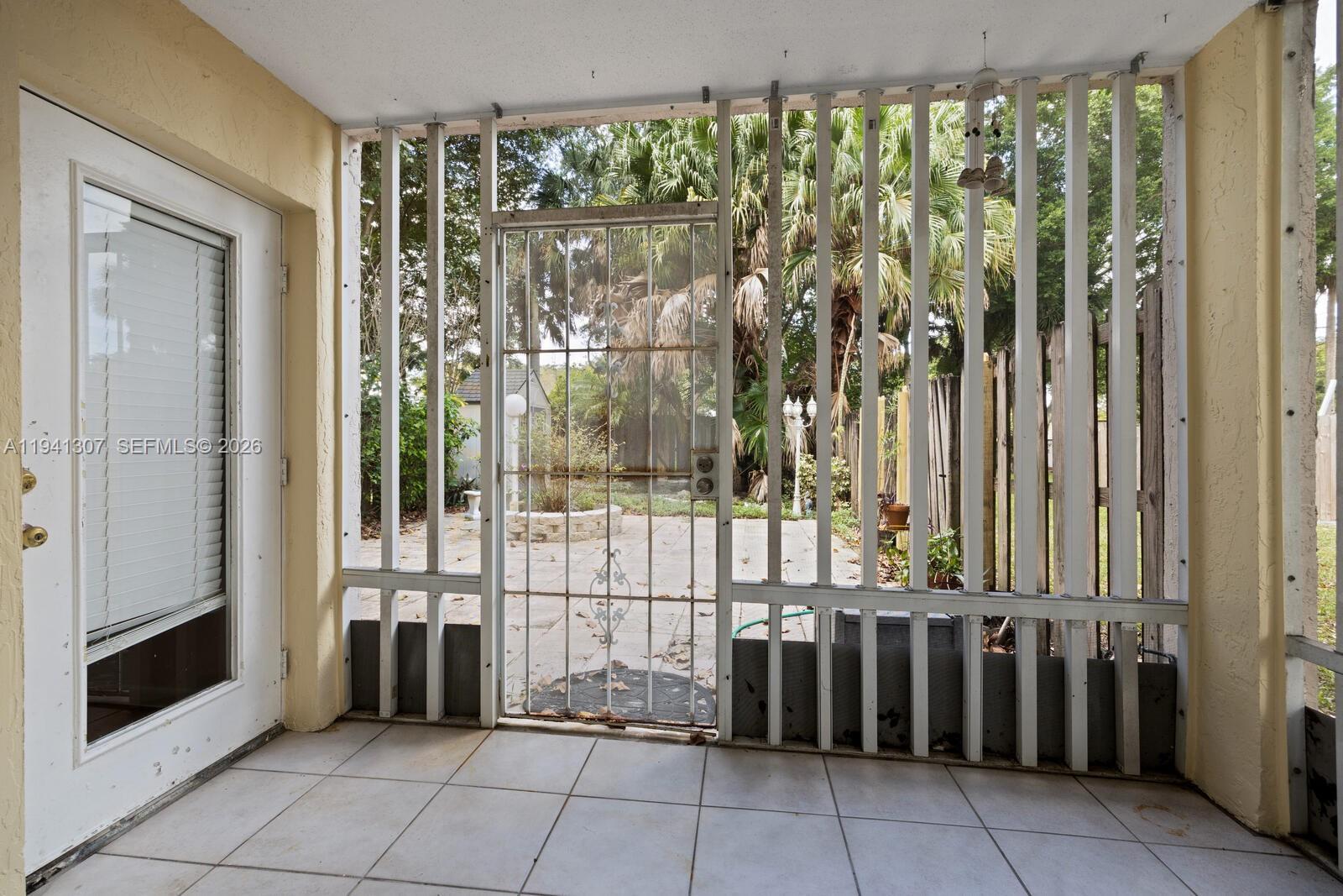 9500 Southwest 140th Court, Unit 9500 Miami, FL 33186 - Photo 19 of 21 a view of a porch with a floor to ceiling window