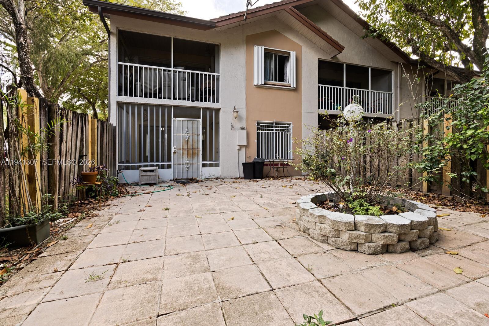 9500 Southwest 140th Court, Unit 9500 Miami, FL 33186 - Photo 21 of 21 a front view of a house with a yard