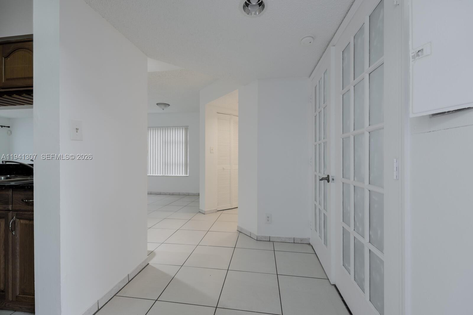 9500 Southwest 140th Court, Unit 9500 Miami, FL 33186 - Photo 3 of 21 a view of an empty room and fire place