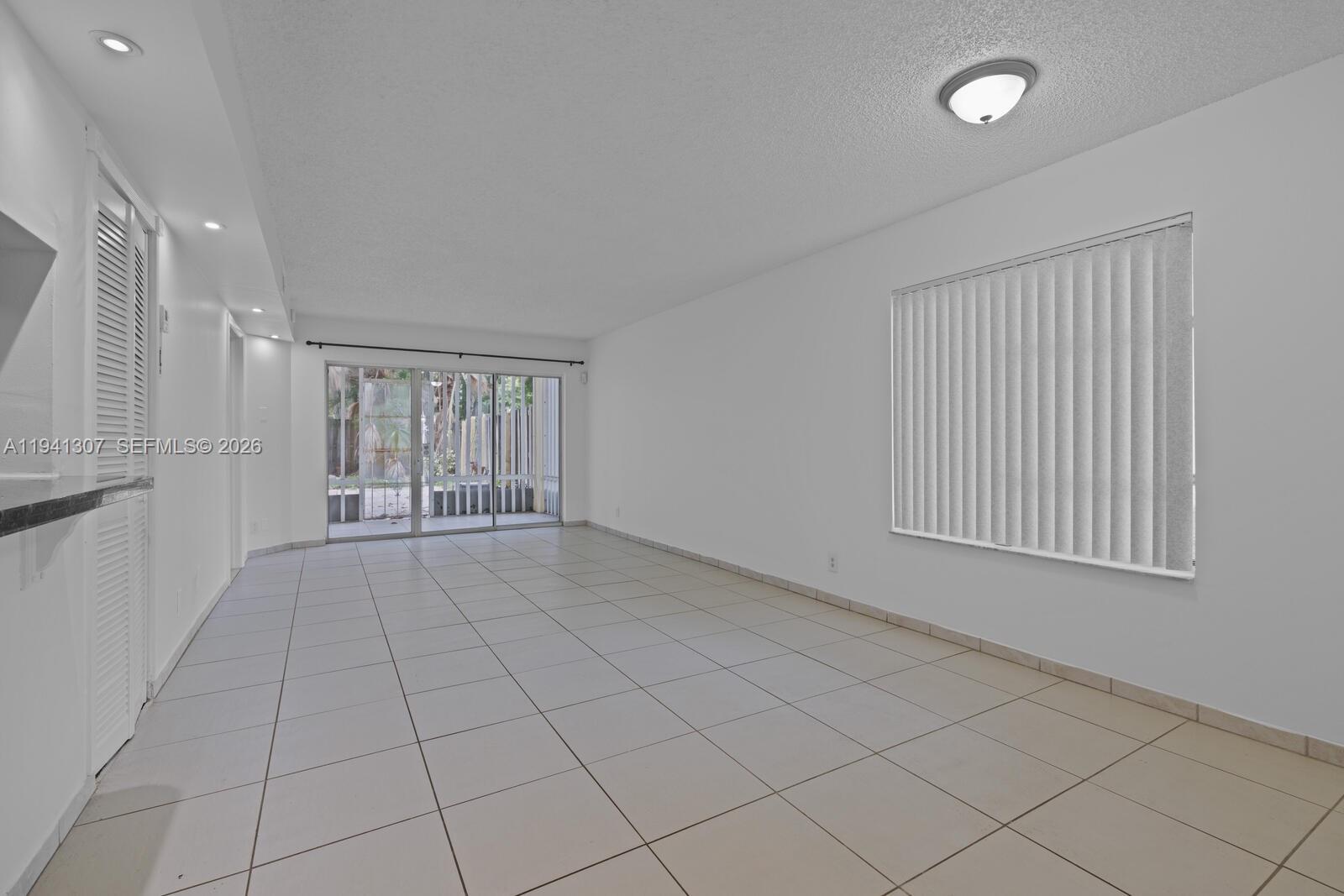 9500 Southwest 140th Court, Unit 9500 Miami, FL 33186 - Photo 4 of 21 a view of an empty room with a window