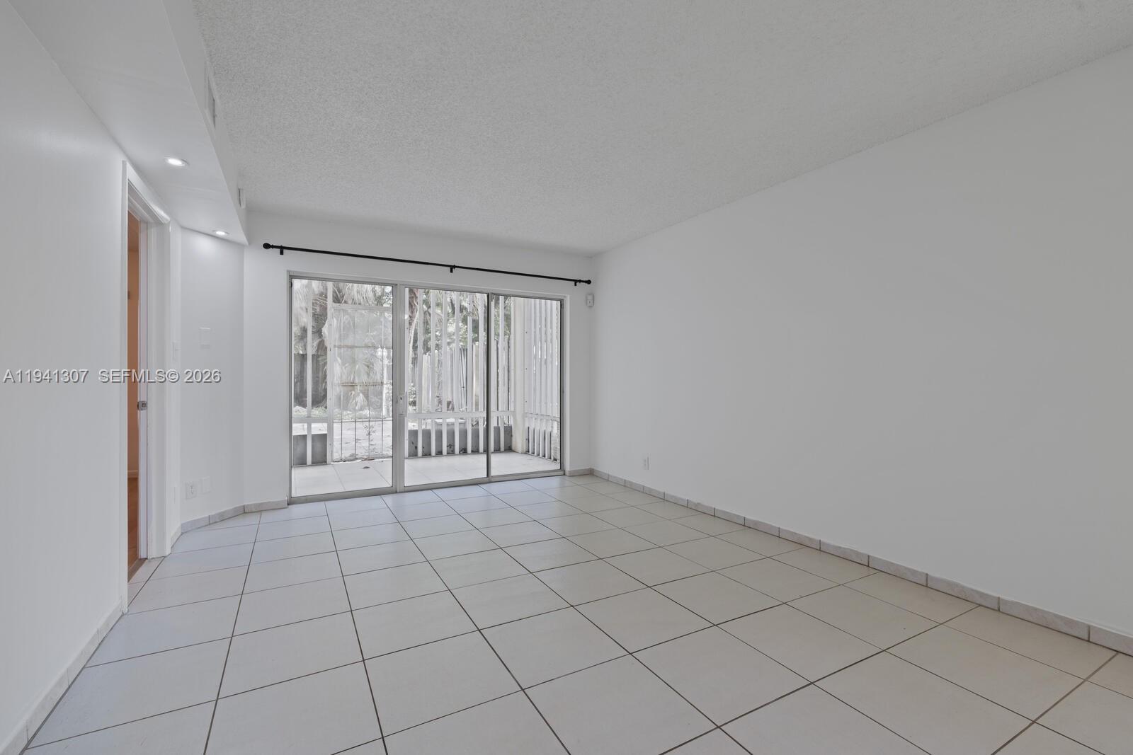 9500 Southwest 140th Court, Unit 9500 Miami, FL 33186 - Photo 5 of 21 a view of an empty room and window