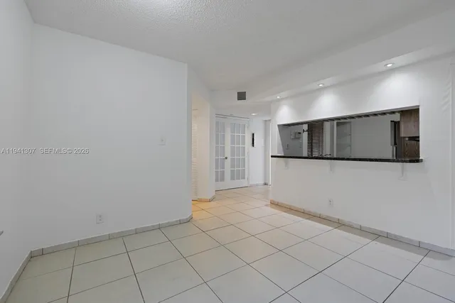 a view of a livingroom with an empty space and a window