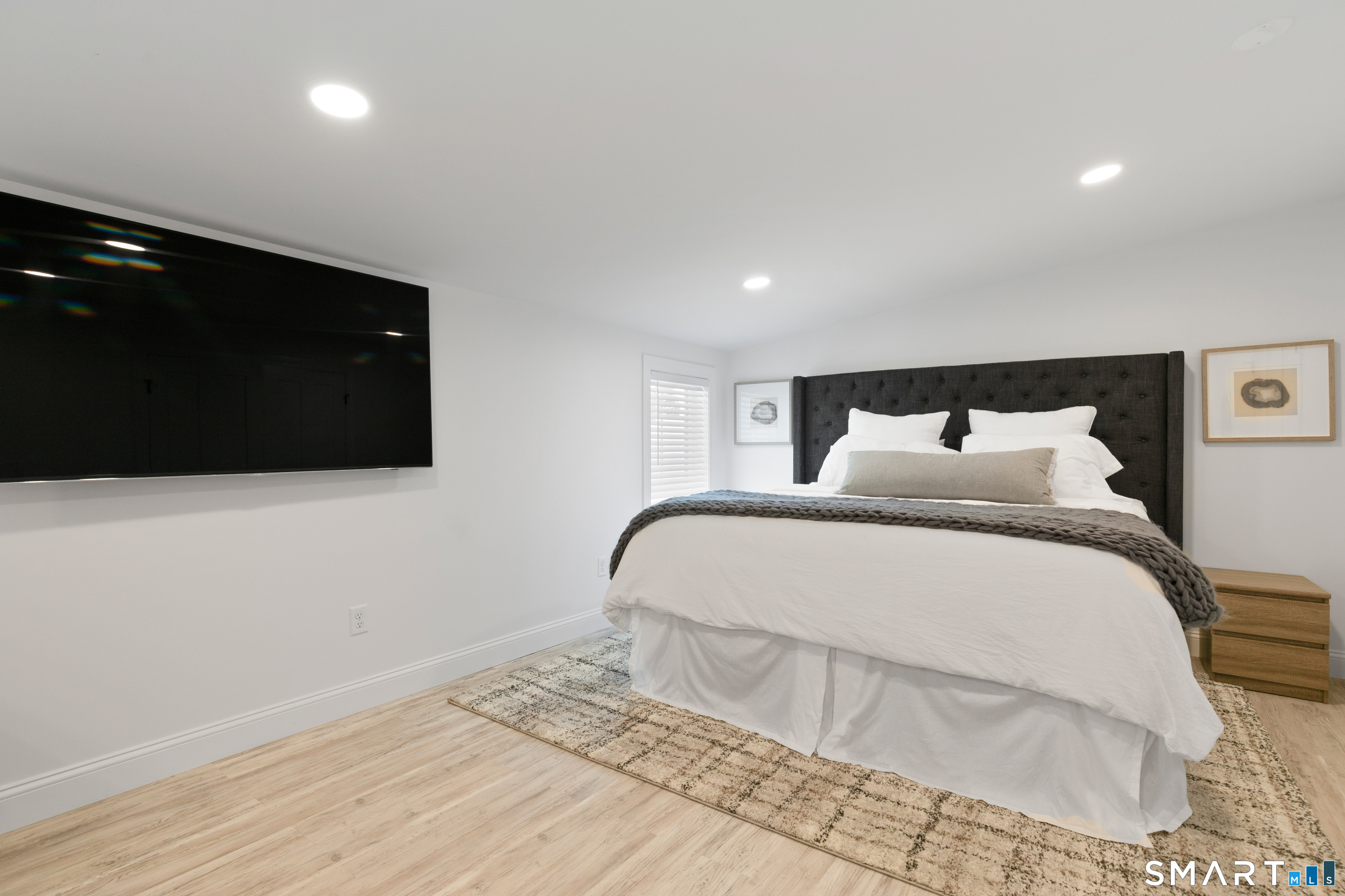 44 Williams Avenue Stonington, CT 06355 - Photo 29 of 39 a bedroom with a bed and a flat screen tv