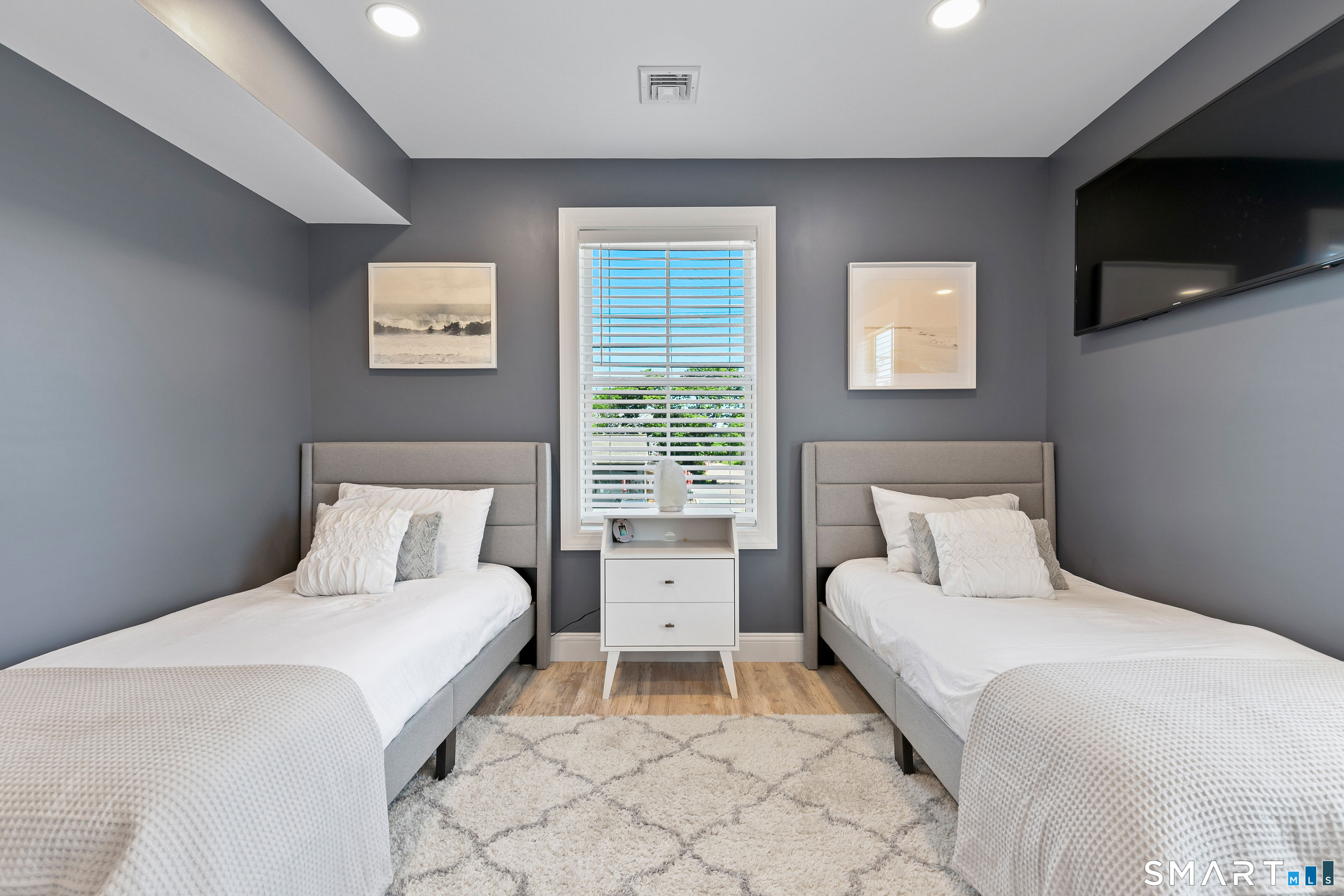 44 Williams Avenue Stonington, CT 06355 - Photo 4 of 39 a bedroom with a bed and a flat screen tv